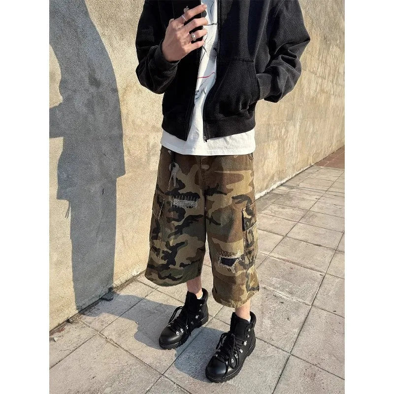 Men's camouflage coloured jeans with patchwork and ripped details, cropped length, straight loose fit.