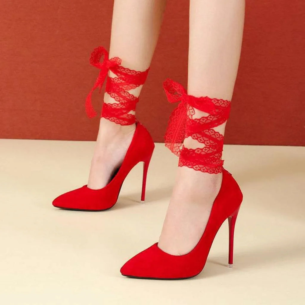 Women's black high-heel court shoe with pointed toe and ankle strap on a white background.
