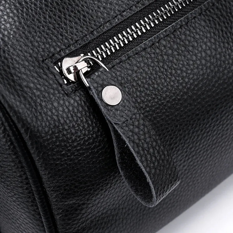 Black genuine leather one-shoulder crossbody bag showing front view and strap.