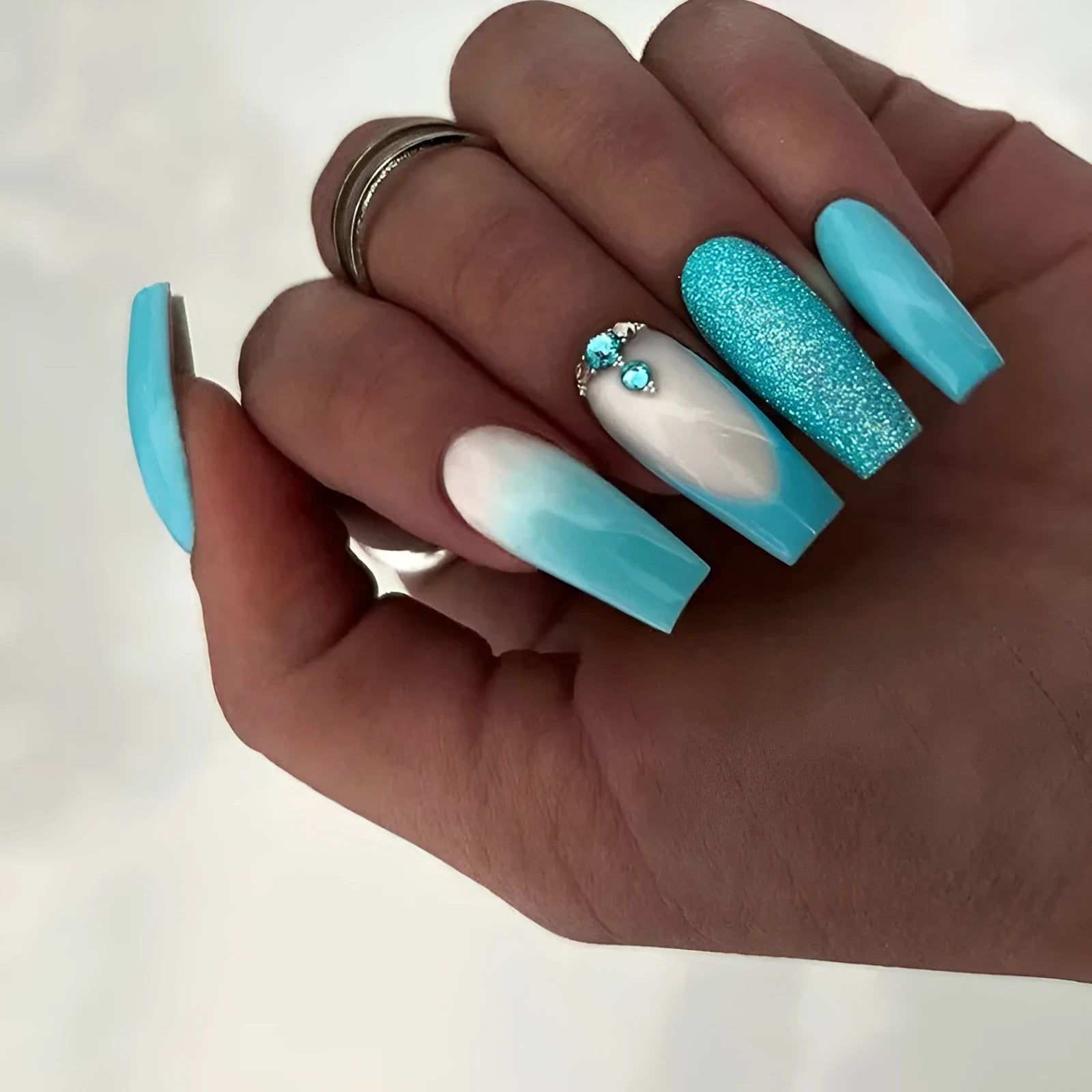 Long ballet false nails in smart blue diamond colour with adhesive glue