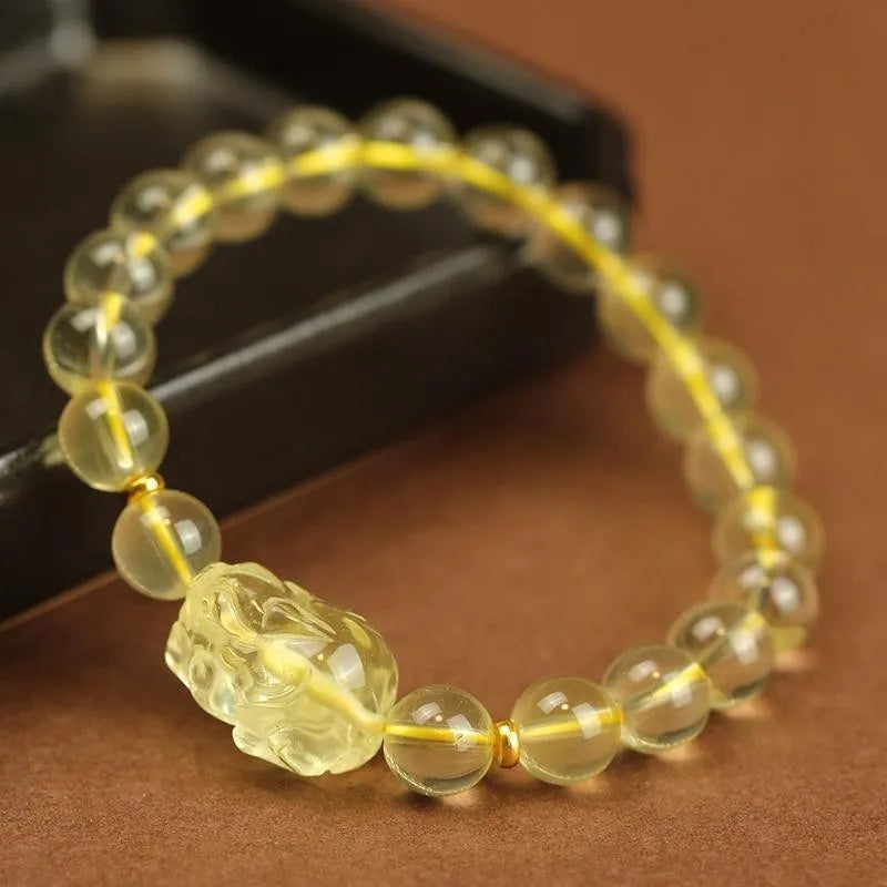 Yellow leather adjustable bracelet with a citrine-coloured artificial crystal Pi Xiu charm.