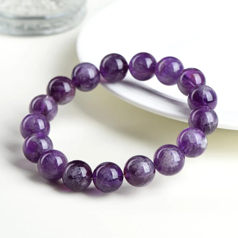 Natural feather amethyst crystal bracelet with scattered beads and Ruyi element on wrist.