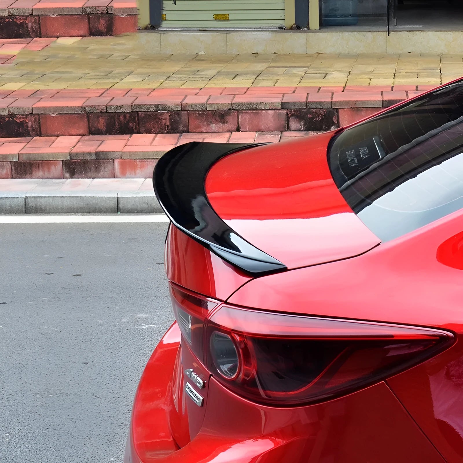 Bright black Mazda 3 tail trim accessory for 2014-2021 Axela Exela models with large fixed blade design