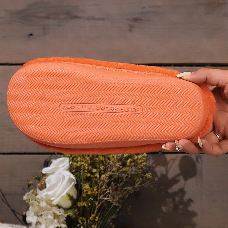 Orange Halloween pumpkin design plush slippers with coral velvet upper and non-slip sole.