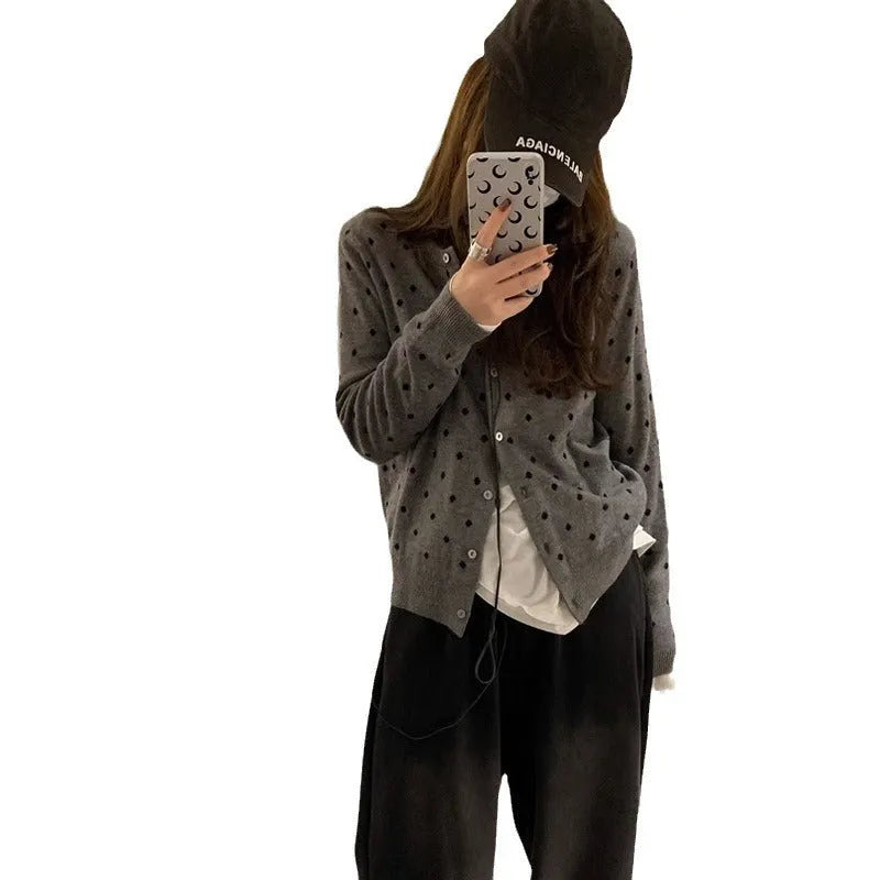 Women's grey dot knitted cardigan with crocheted flower details on sleeves, loose fit.