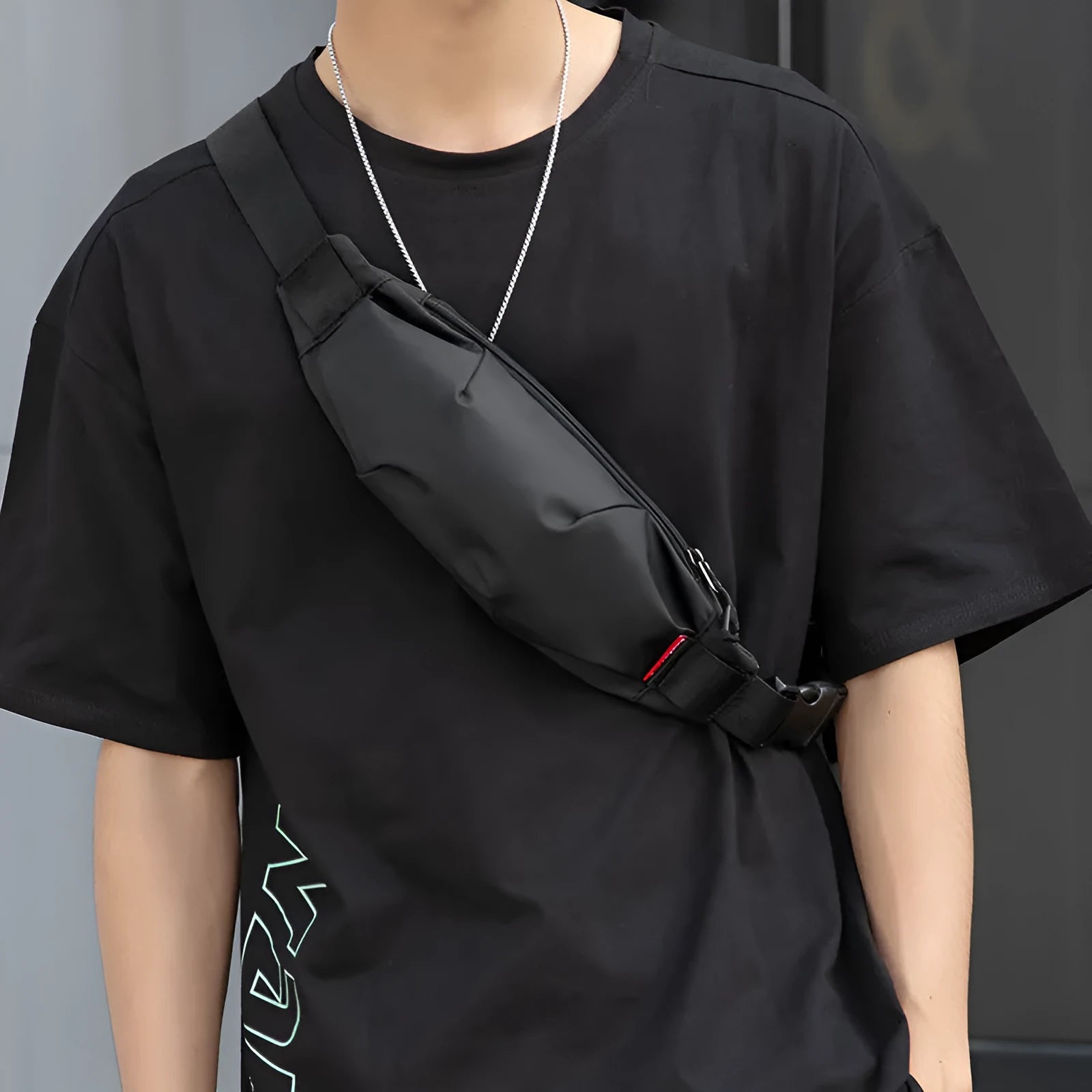 Men's black Oxford cloth crossbody waist pack showing interior organisation pockets