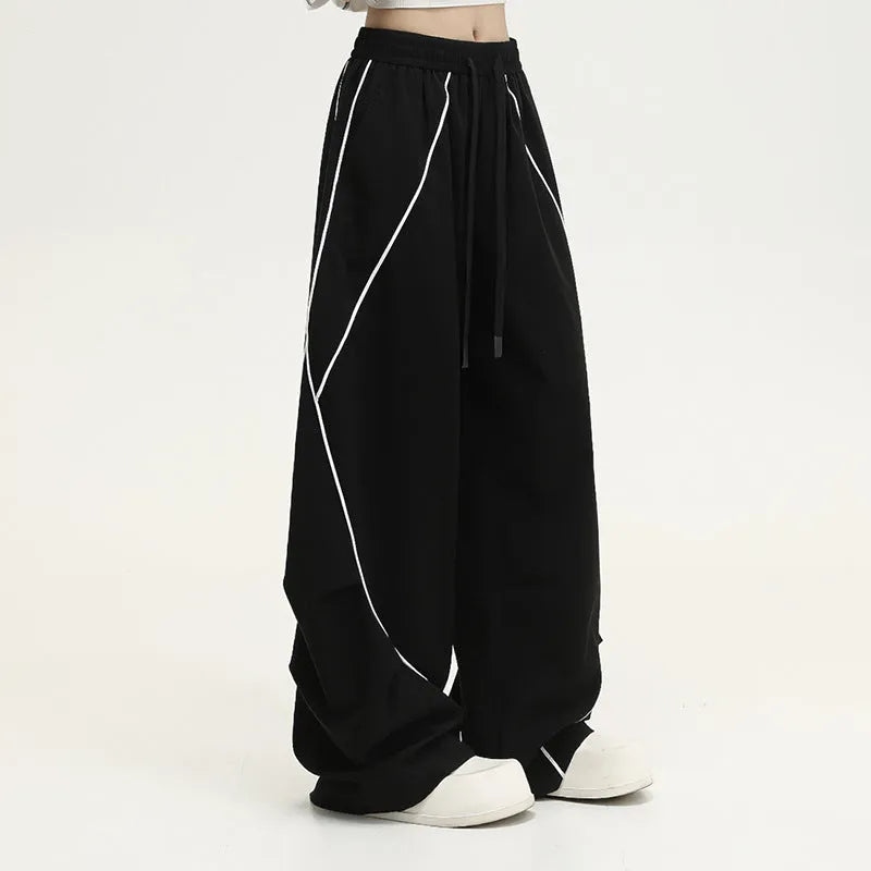 Black pleated wide-leg hip hop sports trousers with a stripe pattern on a mannequin