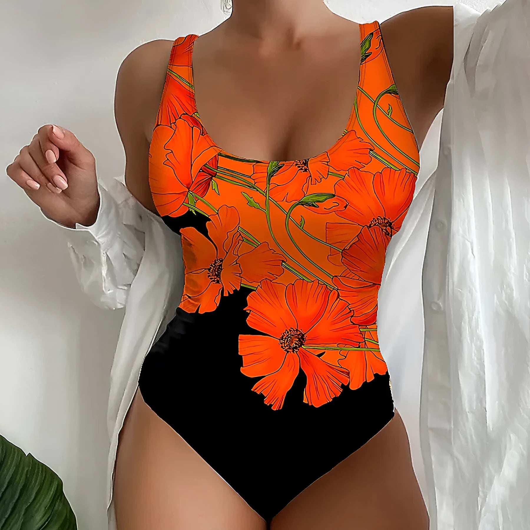 Orange floral print backless one-piece swimsuit on a mannequin.