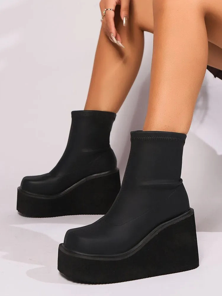 Plus size black women's wedge heel boots with a waterproof platform and round toe.