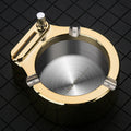 Blue metal ashtray with sliding permanent match lighter and three cigarette slots on a table.