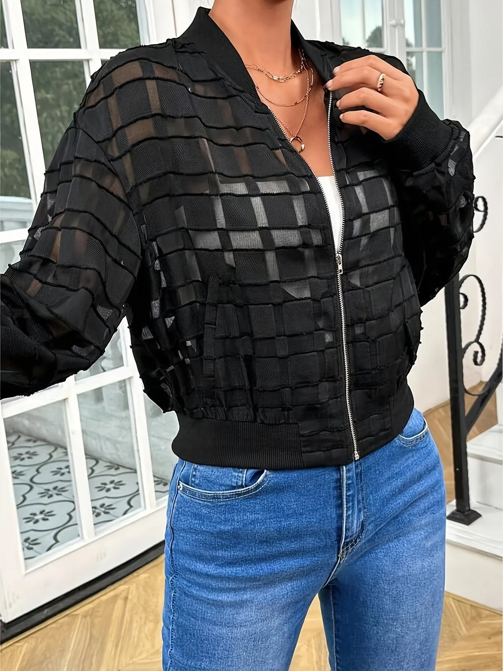 Black women's casual zip jacket with a geometric pattern on semi-transparent polyester fabric.