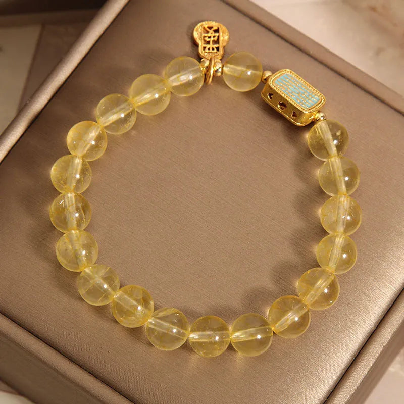 Citrine yellow crystal women's bracelet with sparkling rhinestone decorative elements.