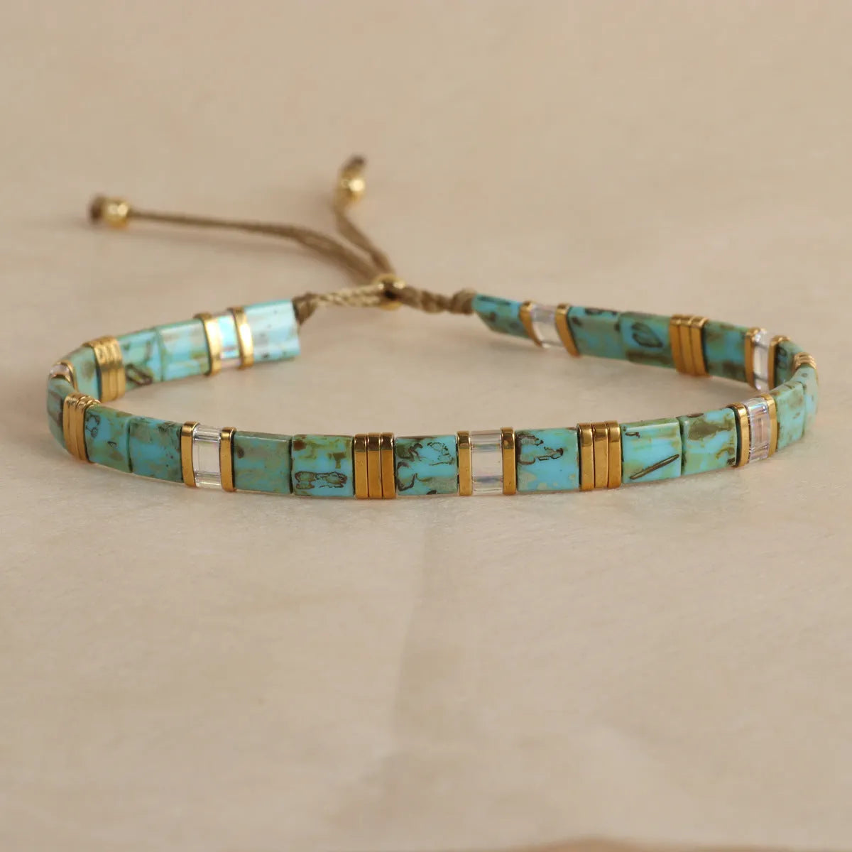 Geometric glass bead bracelet with pull design in milky white colour
