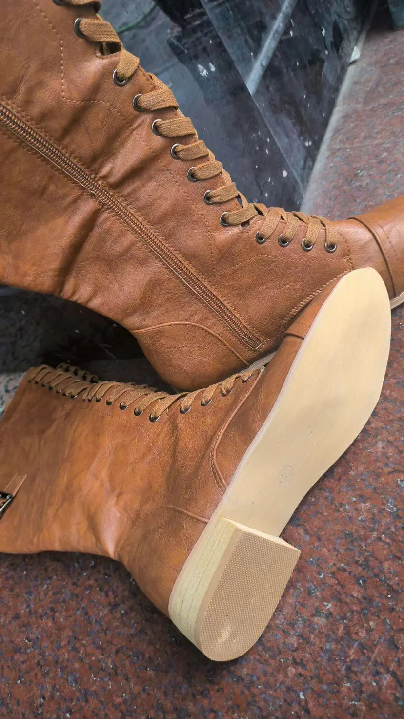 Women's black ankle boot with a cross strap design and zip fastening on the side.
