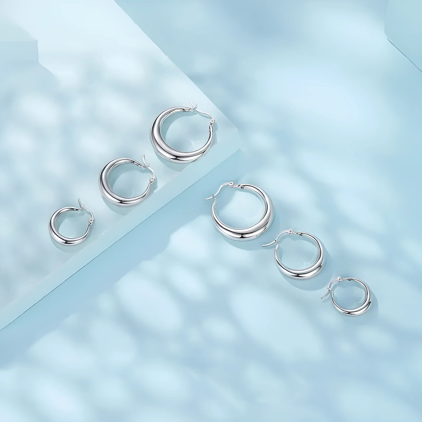 Silver-tone geometric ring clip-on earrings for women, shown in three sizes.