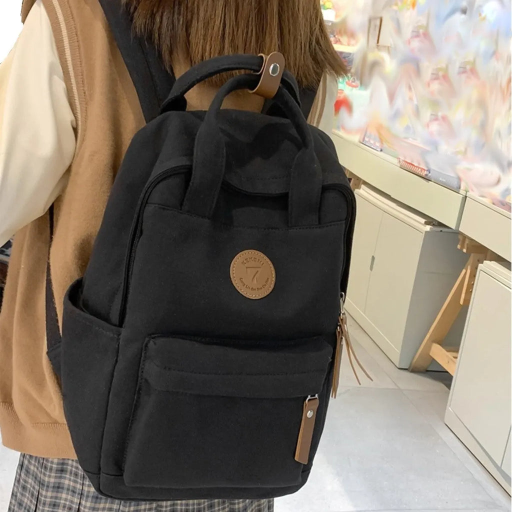 Black Oxford cloth retro backpack with curved shoulder straps for school and travel