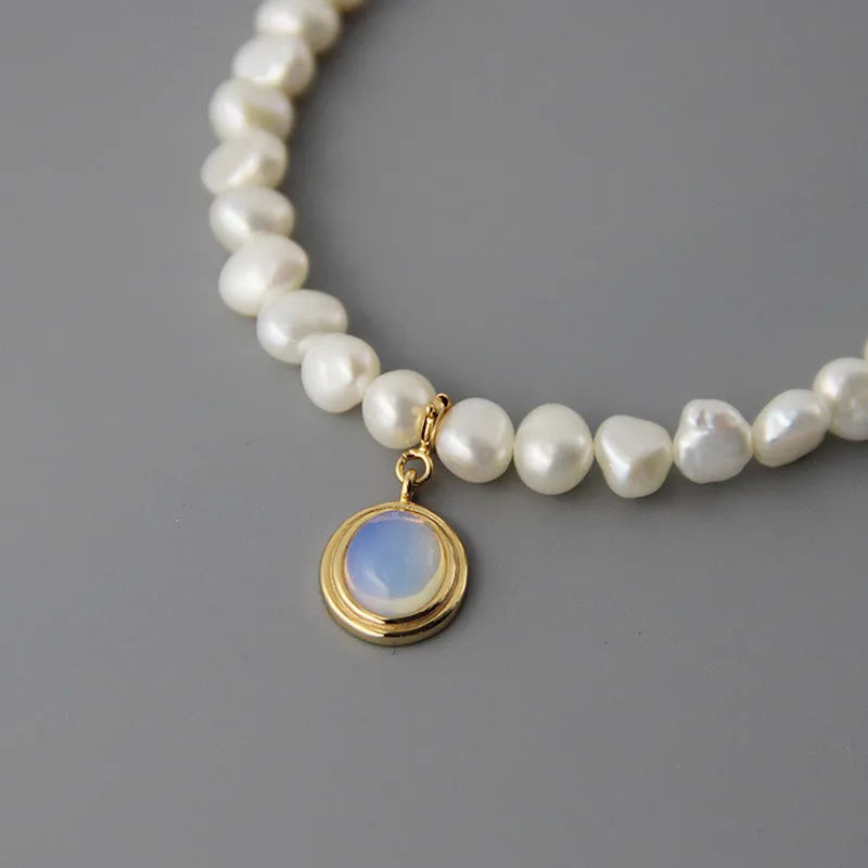 Silver geometric necklace with round medal and pearl pendant on adjustable chain