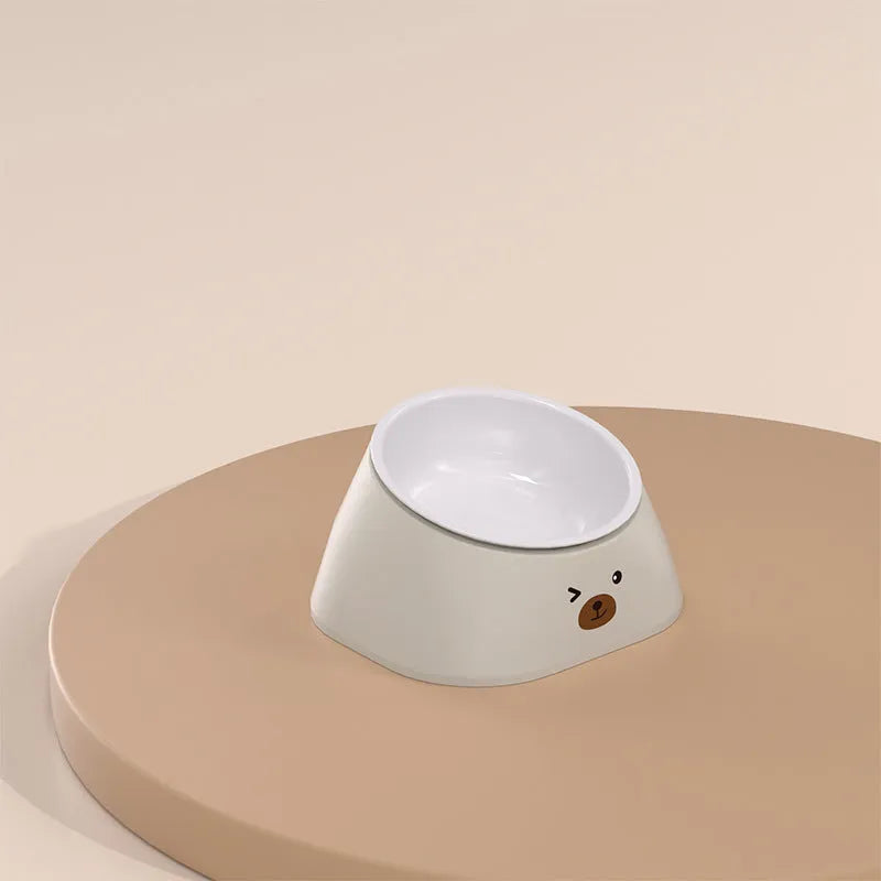 Green tilted stainless steel cat bowl with non-slip white base at a 15 degree angle