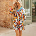 Orange floral stripe bodycon mini dress with V-neck and lace detailing on long sleeves.