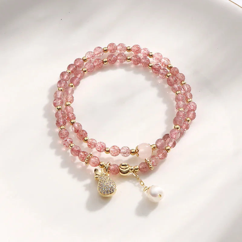 Women's strawberry quartz crystal bracelet with geometric design on wrist