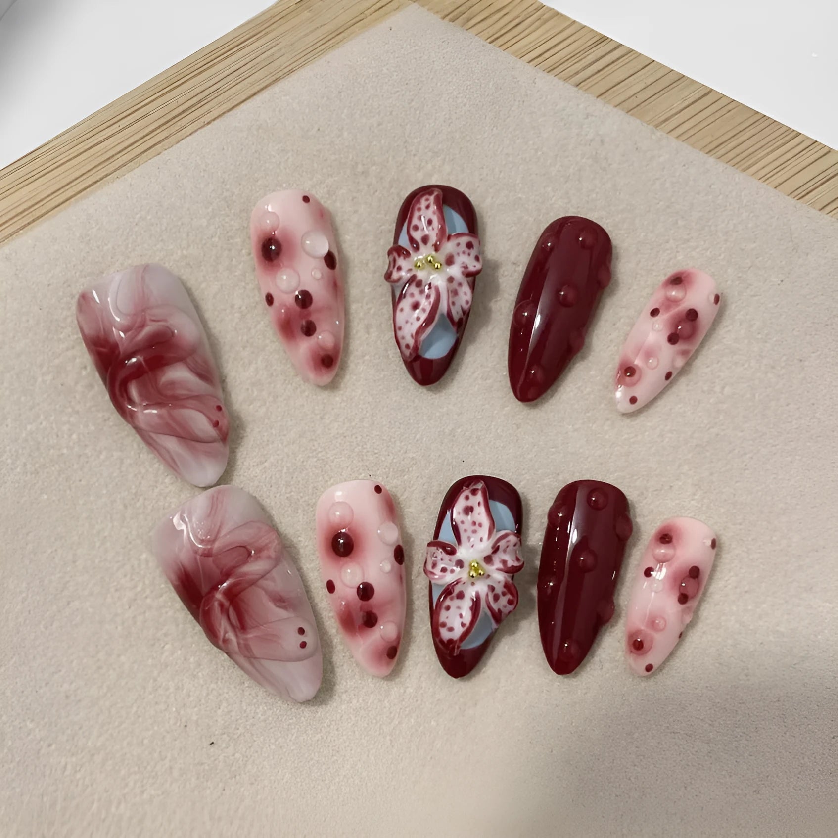 Hand-painted 3D carved manicure nail art set in almond colour with rose, tulip, and leopard print patterns