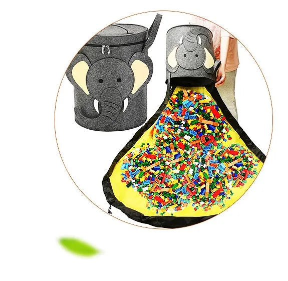Green felt cube storage bag open showing toys inside, laying flat as play mat