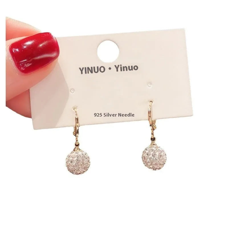 A pair of women's geometric copper earrings with rose details and an electroplated finish.