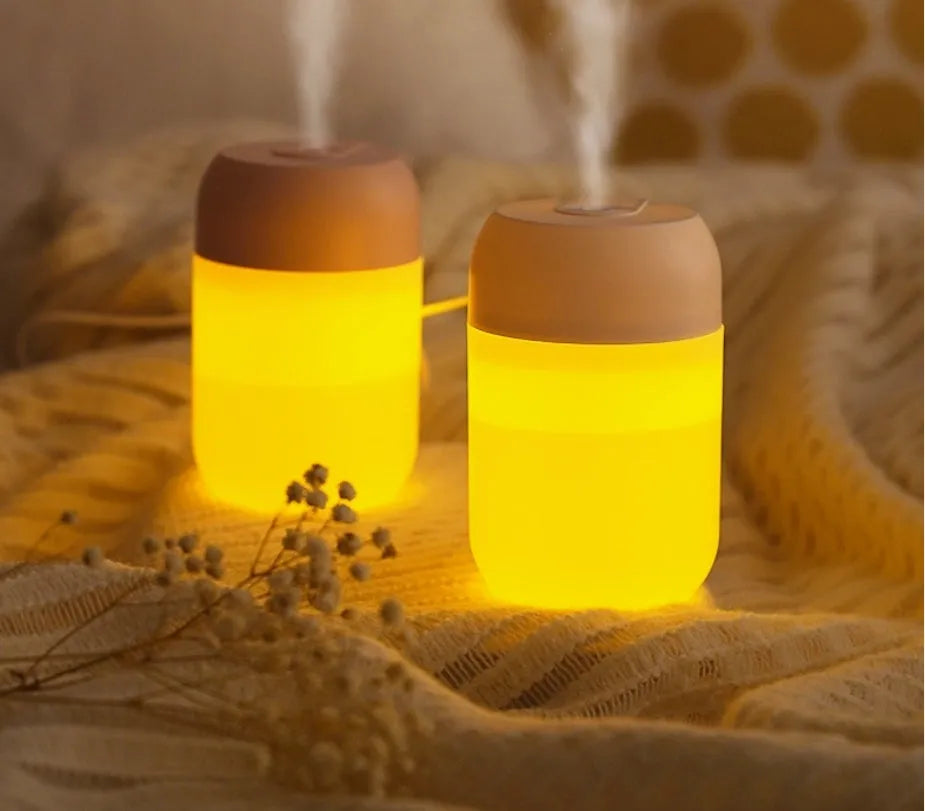 White cylindrical USB-powered mini humidifier with charging cable