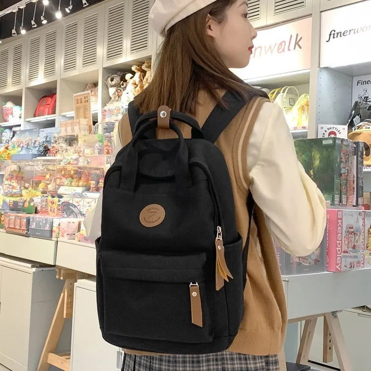 Black Oxford cloth retro backpack with curved shoulder straps for school and travel