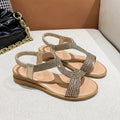 Women's gold PU leather beach sandals with rhinestone decoration on the strap.