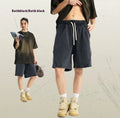 Men's batik-washed cotton terry shorts in a loose fit, shown in a retro colour with patch detail.