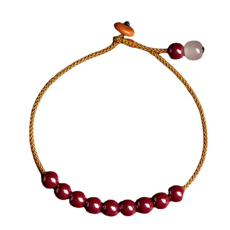 Hand-woven raw cinnabar bracelet with geometric shape on model wrist.