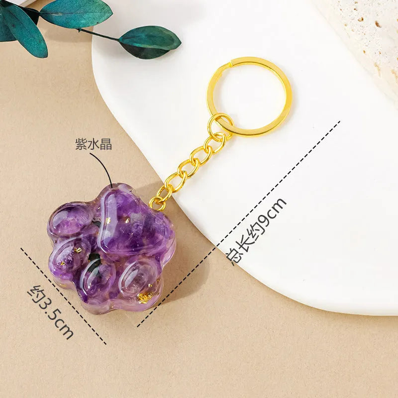 Small natural crystal cat's paw charm on a metal keyring loop.
