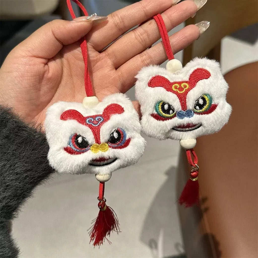 Handmade blue and yellow Chinese style plush lion keychain ornament with tassel and star stone.