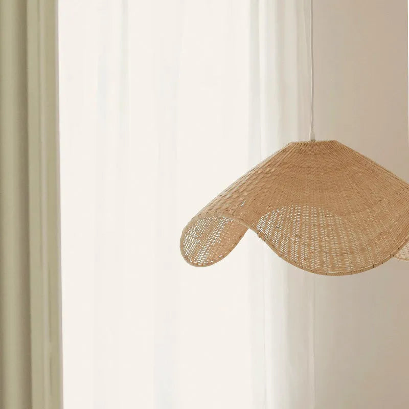 Handmade natural rattan and willow chandelier with warm LED light in a pastoral style.