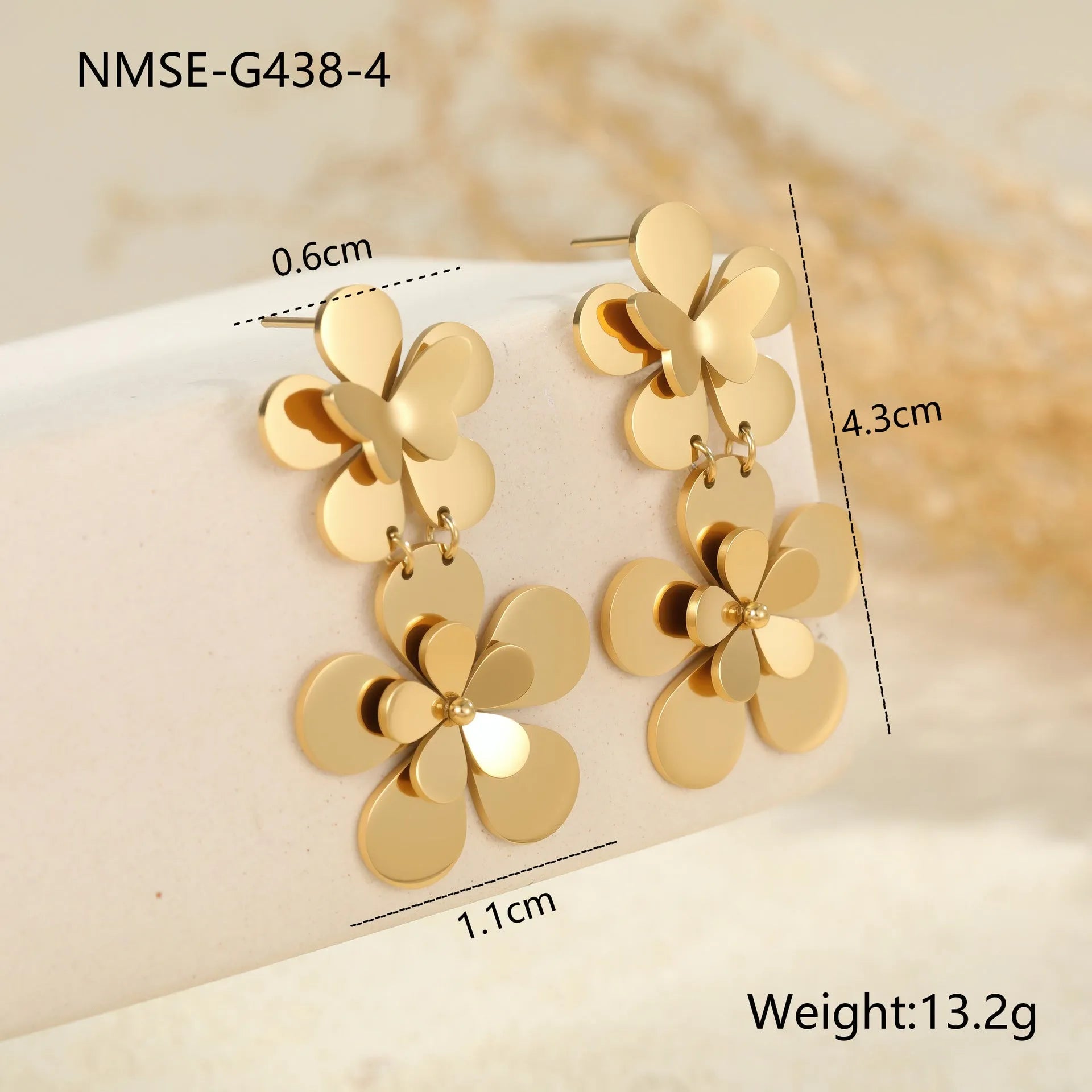 Gold coloured flower butterfly earrings with geometric and zodiac details on stainless steel.