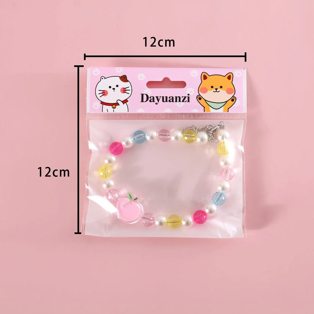 Colourful plastic bead cat necklace with adjustable sizing in peach, rainbow or small flower patterns