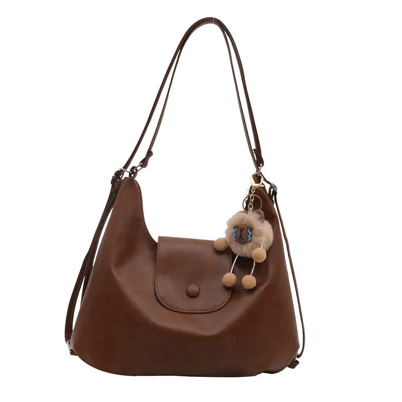 Brown textured PU one-shoulder bag with single strap showing internal phone compartment and horizontal organisation