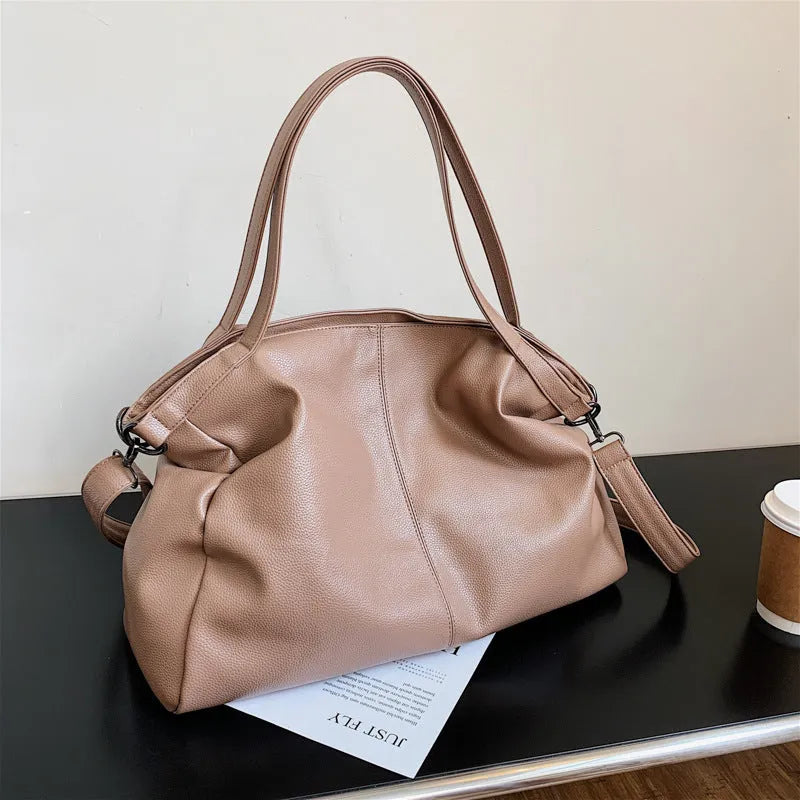 Large soft PU messenger bag in khaki colour with a long shoulder strap, shown open to reveal inner phone pocket.