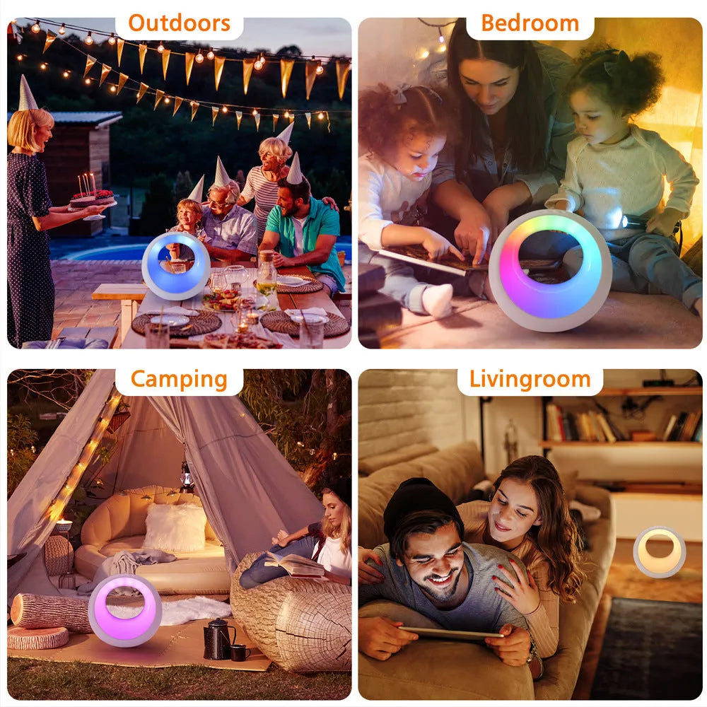 Small white RGB colour changing desk lamp with remote control on a wooden surface.