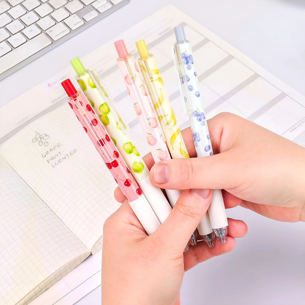 Three fruit-scented press-action pens with 0.5mm quick-drying black ink refills on writing paper