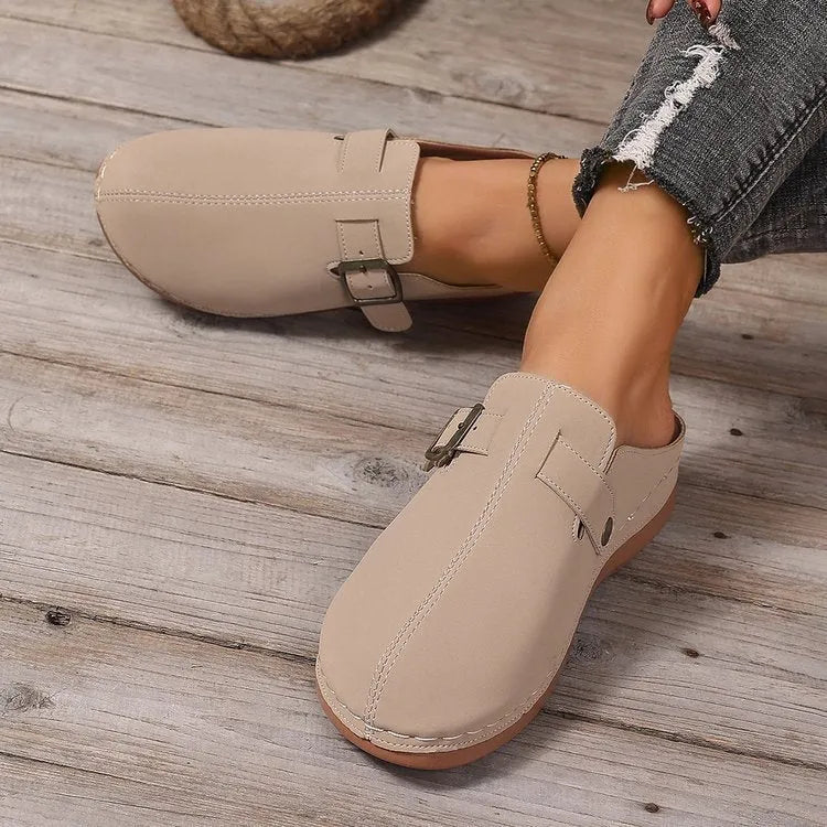 Women's casual wedge slippers in light brown with cloth upper and rubber sole, shown on a foot.