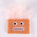 Colourful plush cat toy shaped like an explosion head with a big open mouth, shown in blue.