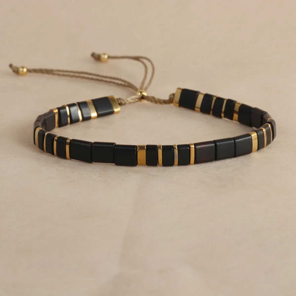 Geometric glass bead bracelet with pull design in milky white colour