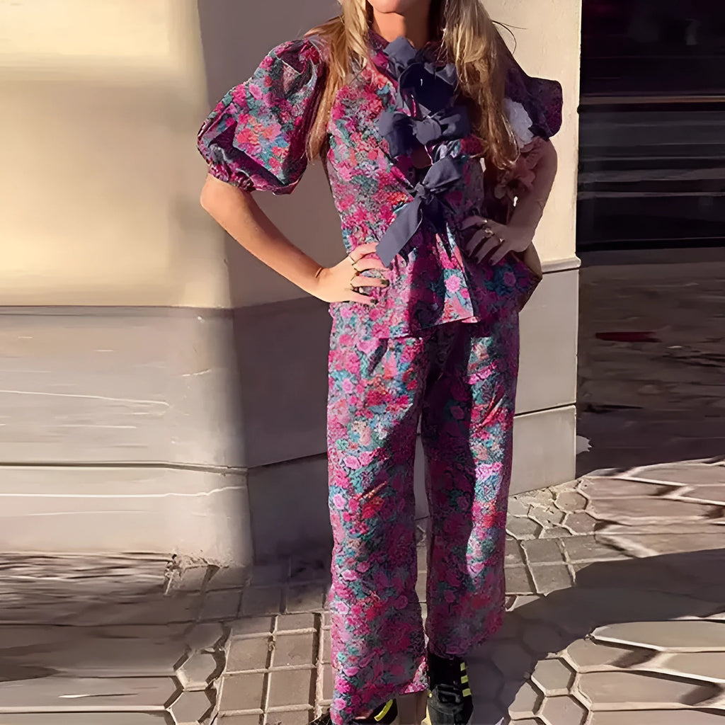 Women's floral print trouser suit co-ord set with puff sleeve top and matching trousers.