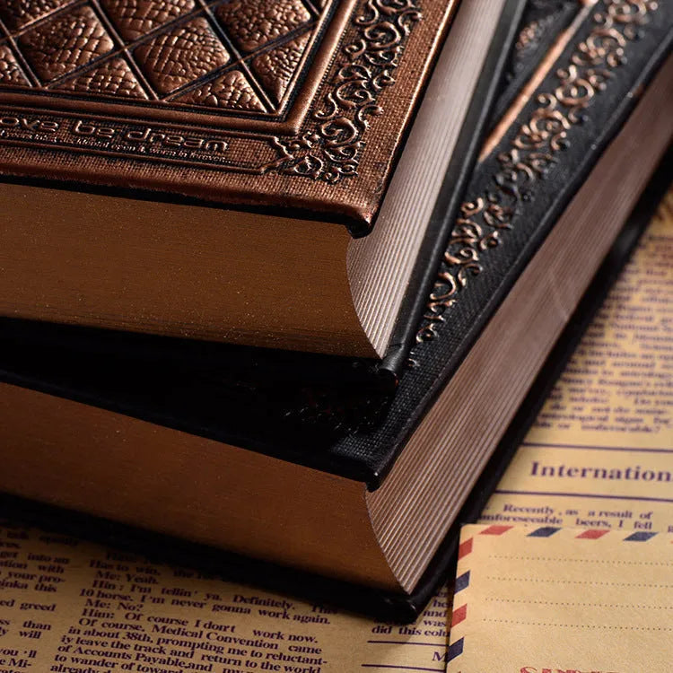 Bronze embossed faux leather A5 notepad with 192 thick unlined pages, lying open.