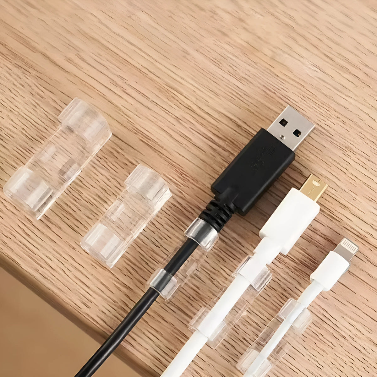 Transparent self-adhesive plastic cable clips in four sizes for wire organisation