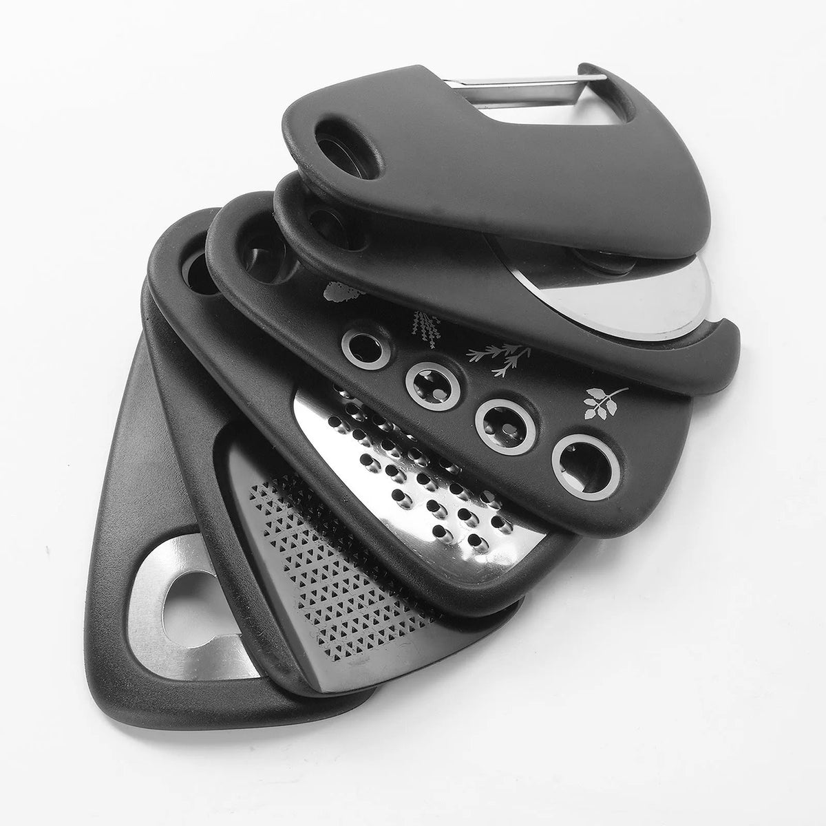 Six stackable kitchen tools and a cleaning brush in a modern colour box.