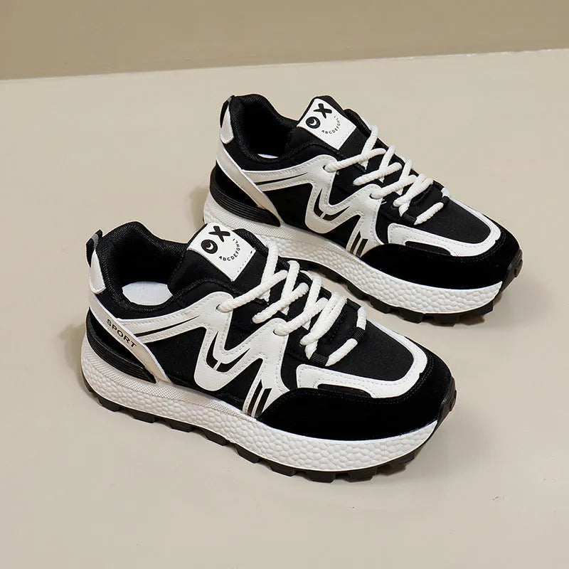 Women's black platform casual sneakers with round toe and front lace-up, showing artificial PU upper and flat sole.