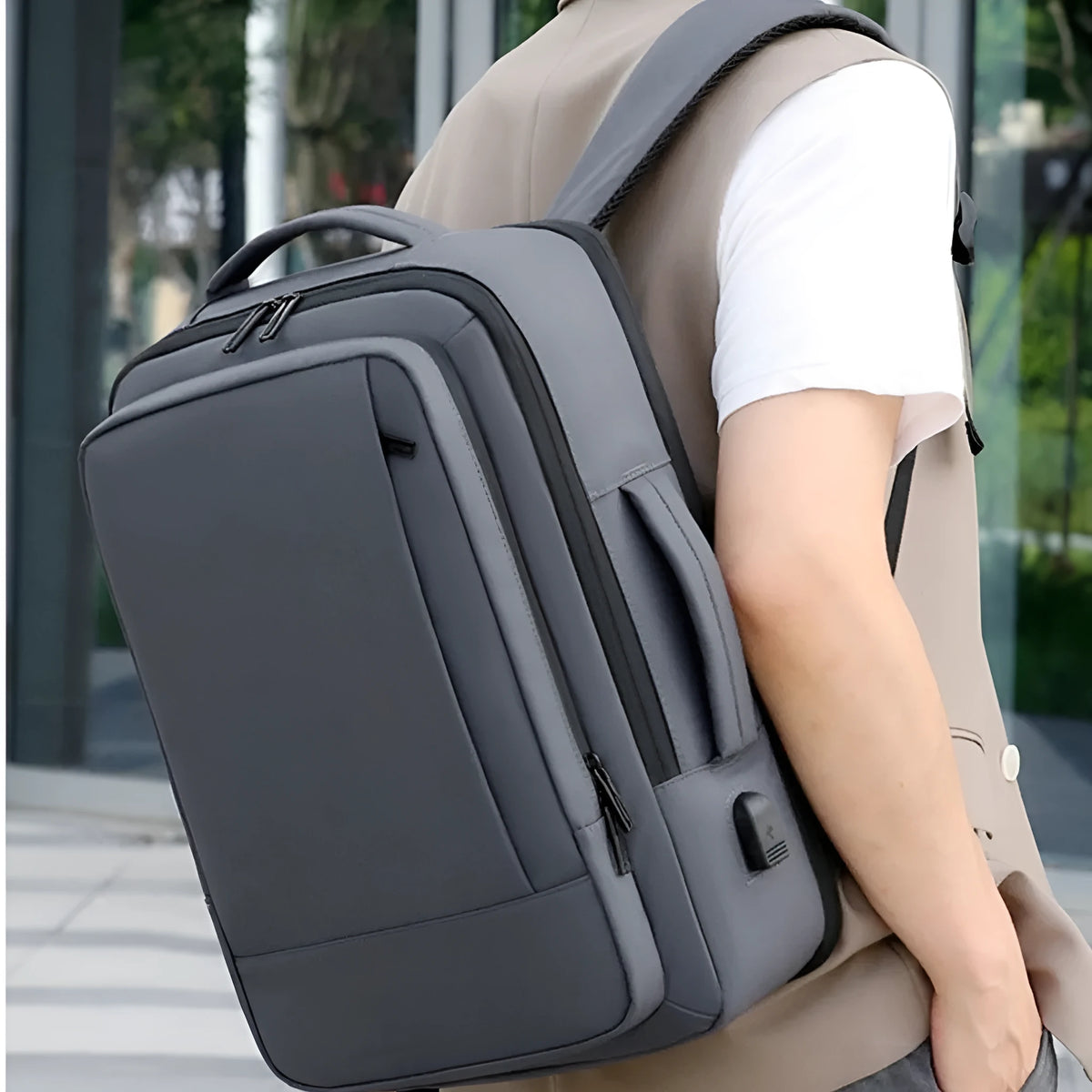 Black or grey waterproof Oxford cloth backpack for men with 20-35L capacity and curved shoulder strap.